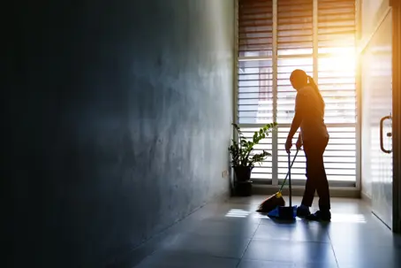 a woman sweeping the floor