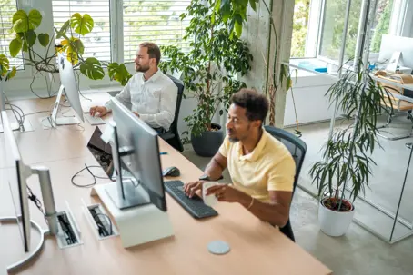 Employees working at modern desks.