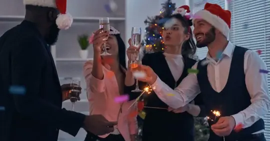people in office toasting champagne at a holiday party